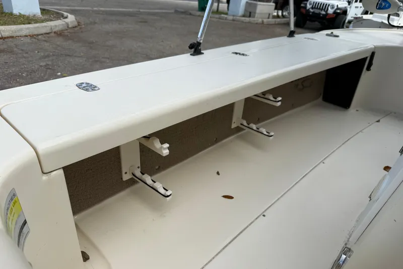 Slide: The Image of 2006 Scout 170 Costa boat interior with storage compartments and rod holders. - 28