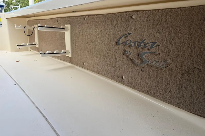 Slide: The Image of 2006 Scout 170 Costa boat interior with rod holders and logo detail. - 30