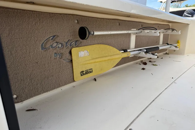 Slide: The Image of 2006 Scout 170 Costa boat interior with paddle storage and Costa branding. - 31