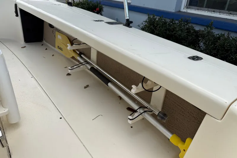 Slide: The Image of 2006 Scout 170 Costa boat interior with rod storage and clean white deck. - 32