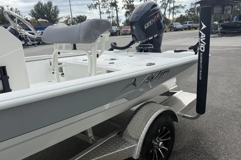 Slide: The Image of 2026 Avid 19 FSX boat on trailer, featuring sleek design and powerful outboard motor. - 2
