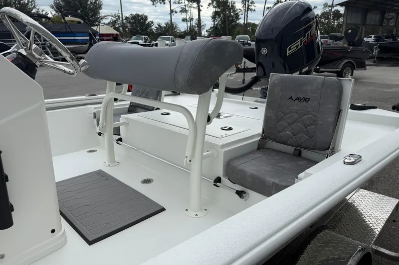 Slide: The Image of 2026 Avid 19 FSX boat interior with gray seating and steering wheel. - 5