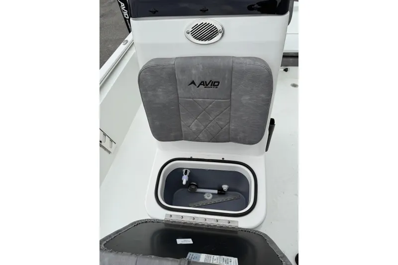 Slide: The Image of 2026 Avid 19 FSX boat seat with storage compartment, featuring gray upholstery and speaker. - 8