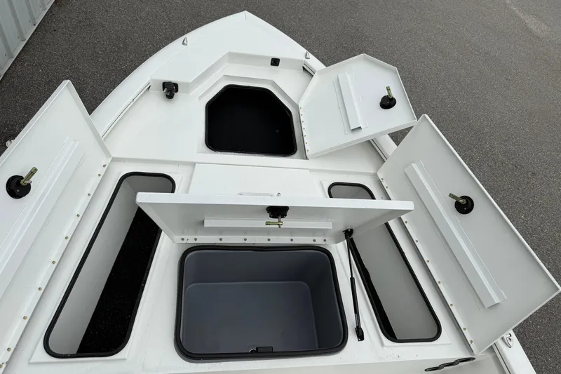 Slide: The Image of 2026 Avid 19 FSX boat with open storage compartments on deck. - 9