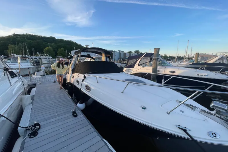 Slide: The Image of 2006 Sea Ray 260 Sundancer docked at marina with person standing nearby. - 23