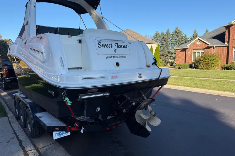 Slide: The Image of 2006 Sea Ray 260 Sundancer boat on trailer, parked in suburban neighborhood. - 26