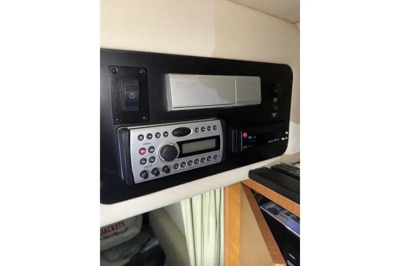 Slide: The Image of 2006 Sea Ray 260 Sundancer boat on trailer, parked outdoors under clear blue sky. - 5