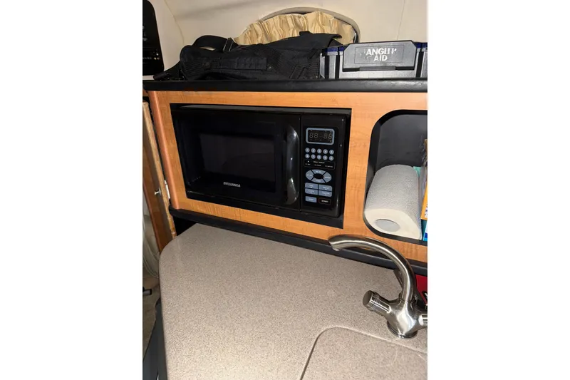 Slide: The Image of 2006 Sea Ray 260 Sundancer boat on trailer under bright blue sky. - 8