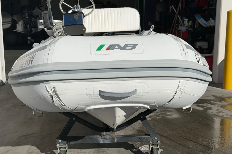Slide: The Image of 2013 AB Inflatables 10VST boat on a trailer in a garage setting. - 3