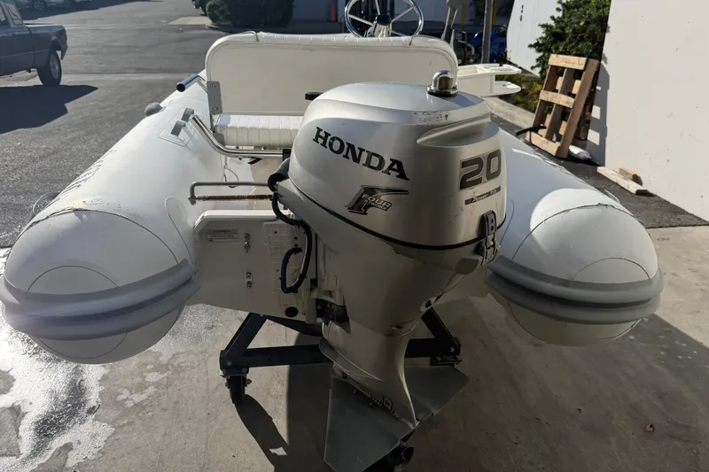 Slide: The Image of 2013 AB Inflatables 10VST boat with Honda 20HP outboard motor in a sunny outdoor setting. - 6