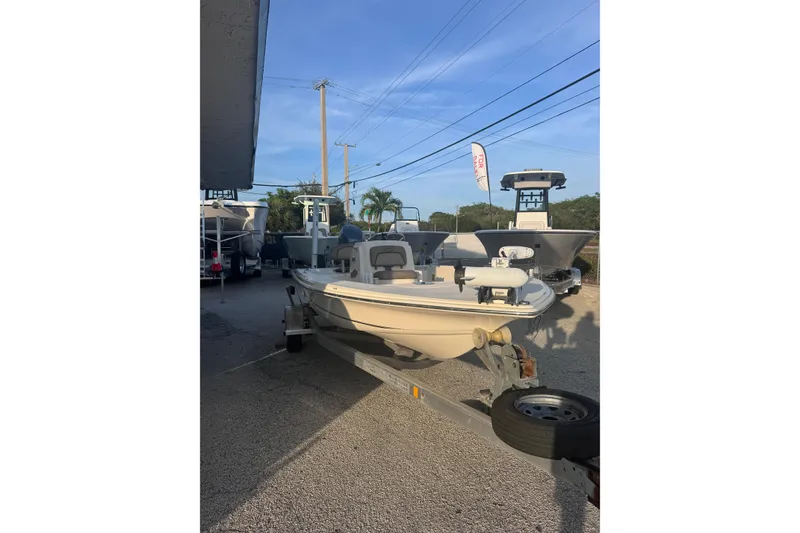 Slide: The Image of 2016 Scout 177 Sport boat on trailer, parked outdoors under clear sky. - 1