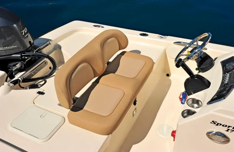 Slide: The Image of Manufacturer Provided Image: 2016 Scout 177 Sport boat interior with tan seating and steering console. - 13