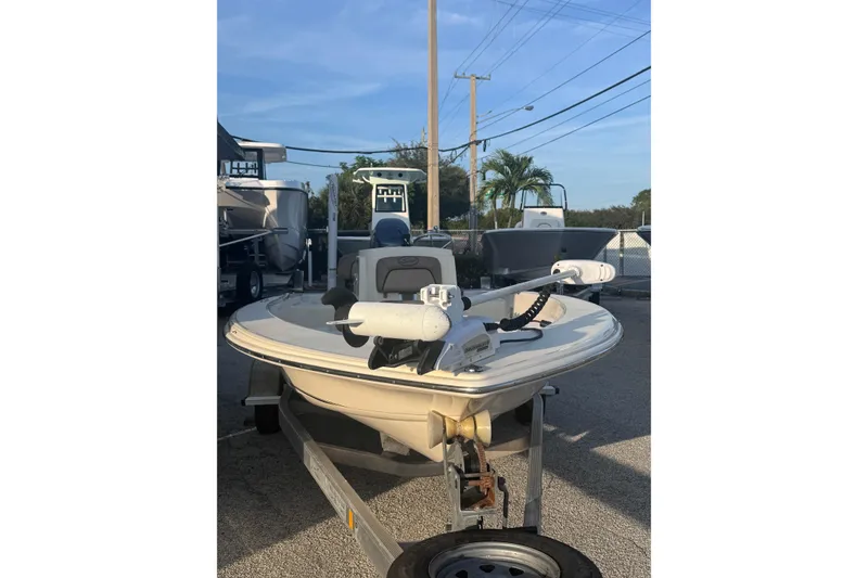 Slide: The Image of 2016 Scout 177 Sport boat on trailer, parked outdoors under clear sky. - 2