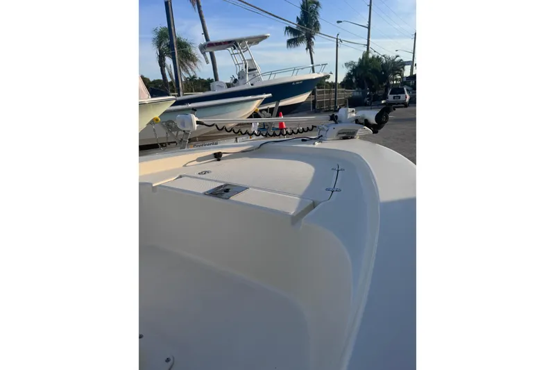 Slide: The Image of 2016 Scout 177 Sport boat with trolling motor, docked near palm trees. - 9