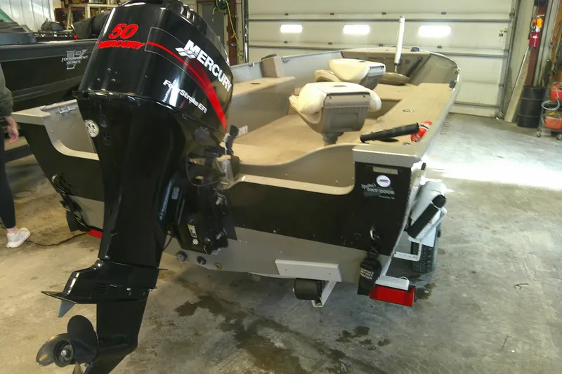Slide: The Image of 2003 Lund 1650 Explorer Tiller boat with Mercury 50 outboard motor in garage. - 10