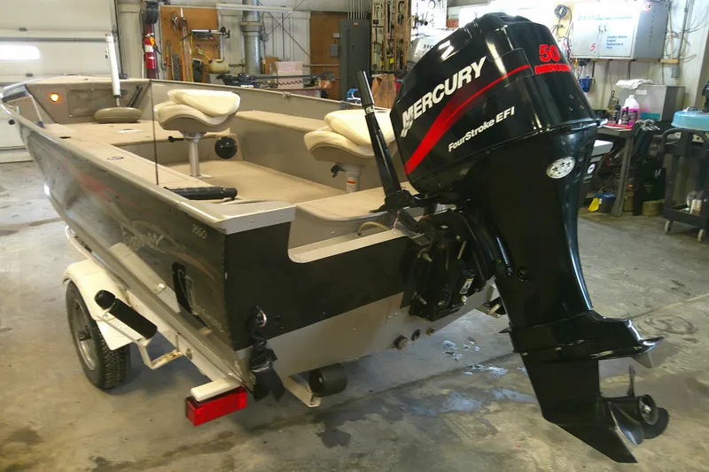 Slide: The Image of 2003 Lund 1650 Explorer Tiller boat with Mercury FourStroke EFI engine in a garage. - 11