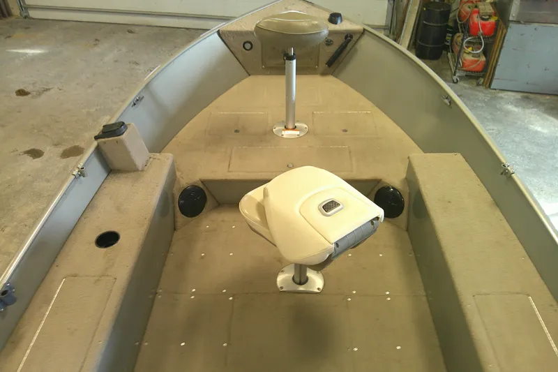 Slide: The Image of 2003 Lund 1650 Explorer Tiller boat interior with seating and storage compartments. - 3