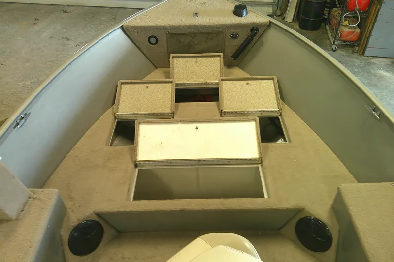 Slide: The Image of 2003 Lund 1650 Explorer Tiller boat interior with open storage compartments. - 4