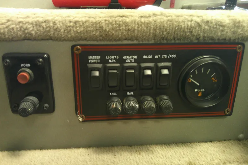 Slide: The Image of Control panel of a 2003 Lund 1650 Explorer Tiller boat with switches and fuel gauge. - 7