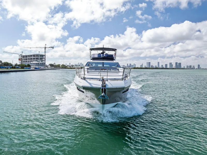 Slide: The Image of Azimut 77S yacht cruising in open water, 2017 model, city skyline in background. - 40