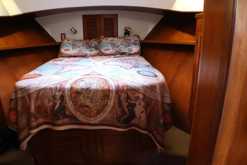 Slide: The Image of Cozy cabin interior of 1988 Sea Ranger 46 Sundeck Trawler with decorative bedding. - 13