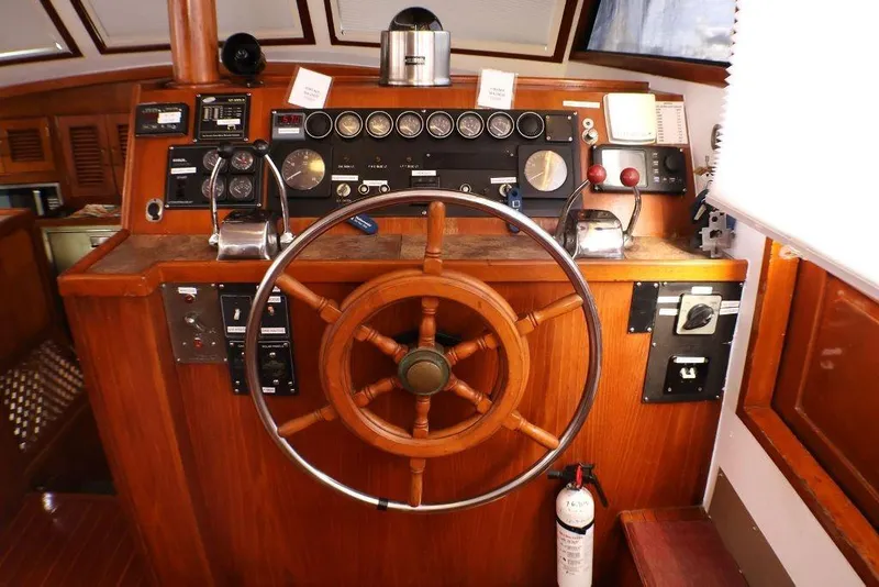 Slide: The Image of 1988 Sea Ranger 46 Sundeck Trawler helm with wooden wheel and navigation instruments. - 14