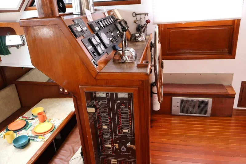 Slide: The Image of 1988 Sea Ranger 46 Sundeck Trawler helm with wooden interior and dining area. - 16