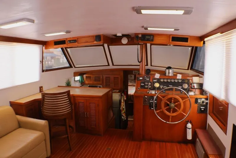 Slide: The Image of 1988 Sea Ranger 46 Sundeck Trawler interior with wooden helm and seating area. - 17