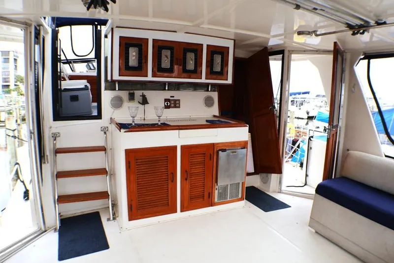 Slide: The Image of 1988 Sea Ranger 46 Sundeck Trawler interior with wooden cabinets and nautical decor. - 22