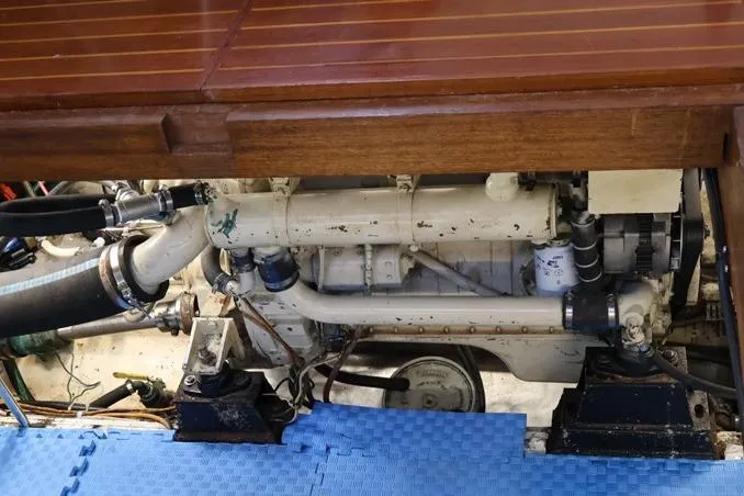 Slide: The Image of Engine compartment of 1988 Sea Ranger 46 Sundeck Trawler with visible components and blue mat. - 24
