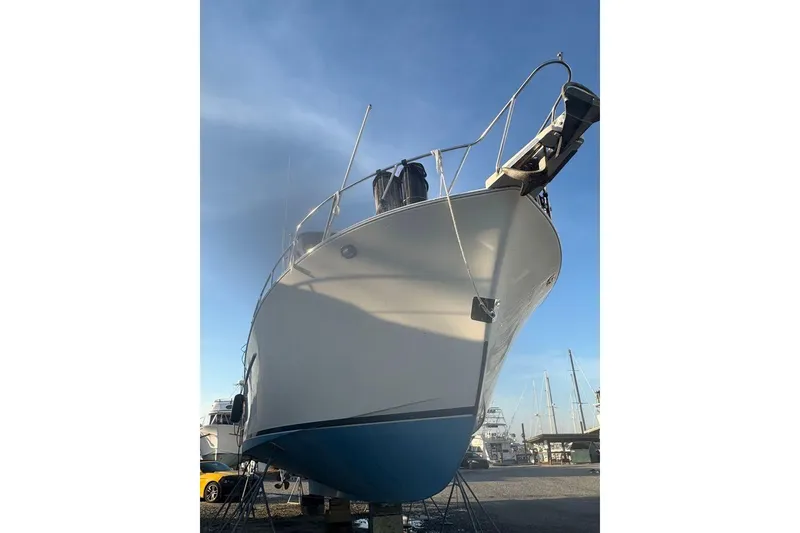 Slide: The Image of 1988 Sea Ranger 46 Sundeck Trawler on dry dock under clear blue sky. - 3