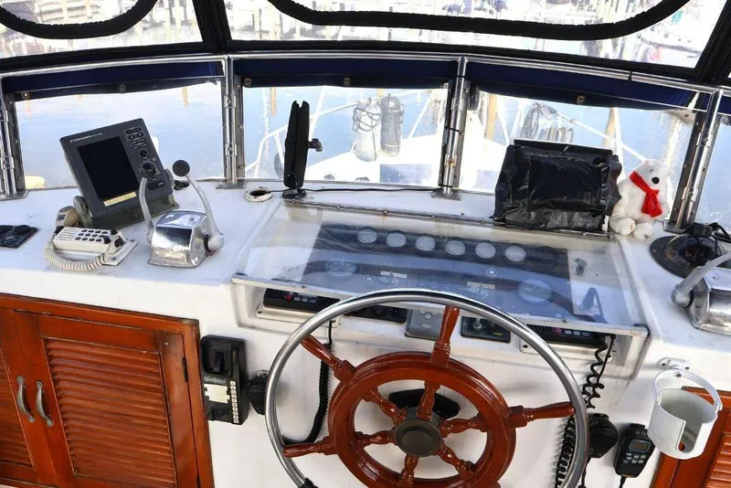 Slide: The Image of 1988 Sea Ranger 46 Sundeck Trawler helm with wooden wheel and navigation equipment. - 7