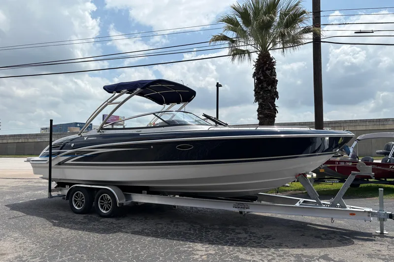 The Image of 2026 Formula 270 Bowrider boat on trailer, parked outdoors under cloudy sky. - 0