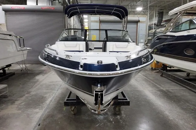 Slide: The Image of 2026 Formula 270 Bowrider boat in showroom, front view with blue and white design. - 27