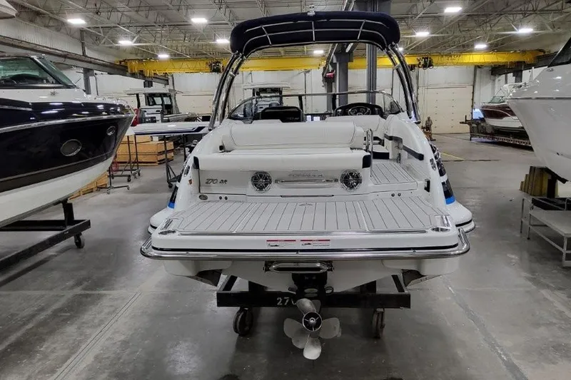 Slide: The Image of 2026 Formula 270 Bowrider boat in a showroom, rear view with sleek design. - 28