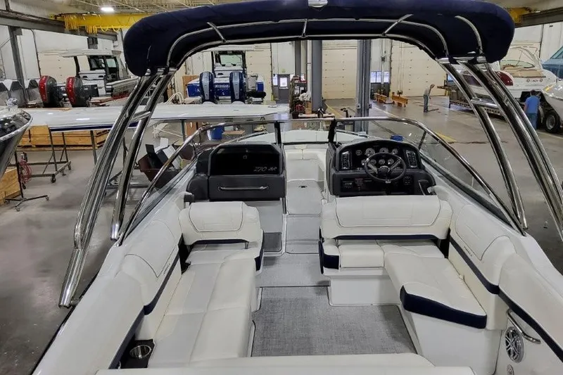 Slide: The Image of 2026 Formula 270 Bowrider interior with sleek seating and modern dashboard in a workshop setting. - 32