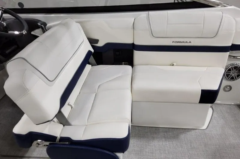 Slide: The Image of 2026 Formula 270 Bowrider interior seating, featuring white and navy upholstery. - 38