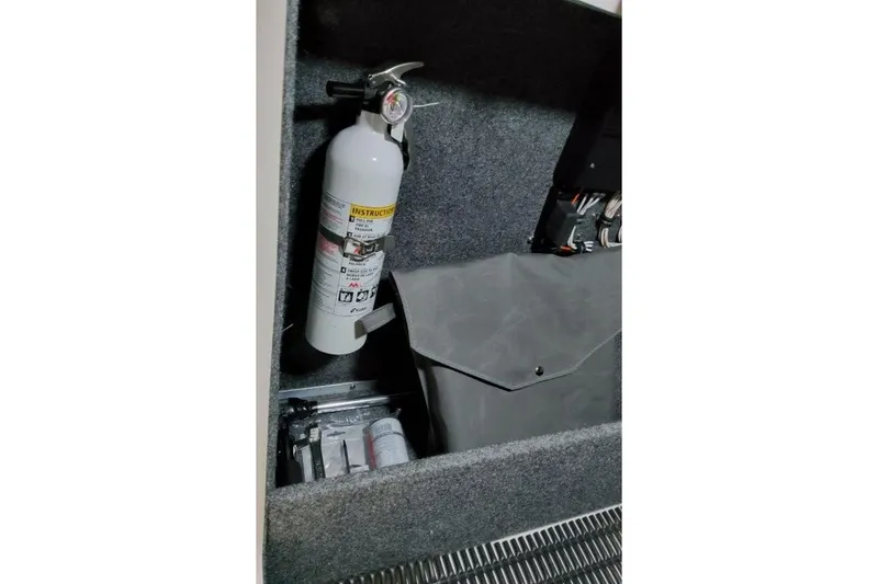 Slide: The Image of Fire extinguisher and equipment storage in 2026 Formula 270 Bowrider boat compartment. - 46