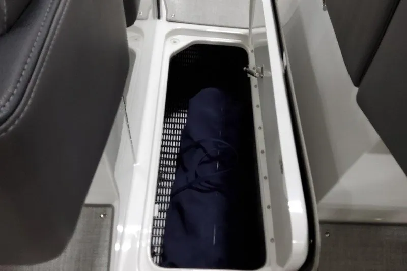 Slide: The Image of Storage compartment in 2026 Formula 270 Bowrider boat with a blue bag inside. - 47