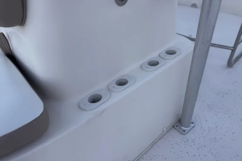 Slide: The Image of 2013 Carolina Skiff 218 boat interior with rod holders and seating area. - 14