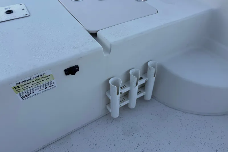 Slide: The Image of 2013 Carolina Skiff 218 boat interior with rod holders and capacity label. - 15