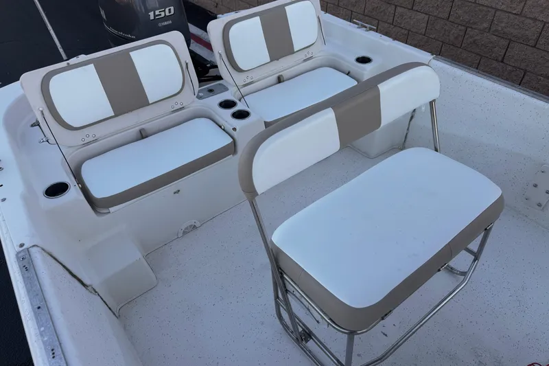 Slide: The Image of 2013 Carolina Skiff 218 boat interior with white and beige seating and cup holders. - 17