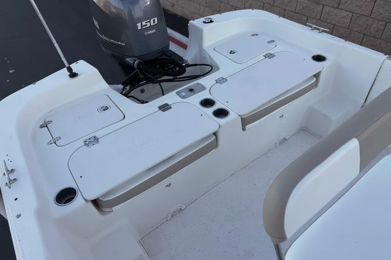 Slide: The Image of 2013 Carolina Skiff 218 boat interior with Yamaha 150 outboard motor. - 18