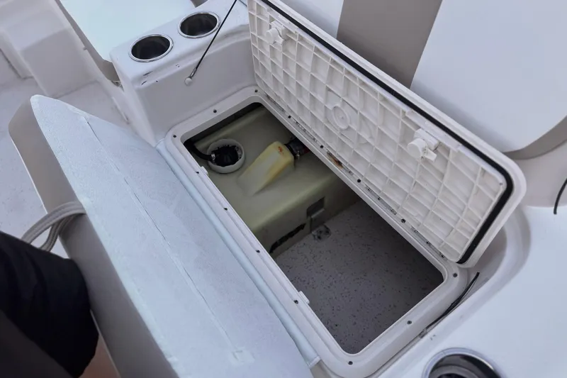 Slide: The Image of Open storage compartment on 2013 Carolina Skiff 218 boat, showing interior details. - 21