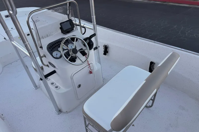 Slide: The Image of 2013 Carolina Skiff 218 boat interior with steering console and seating. - 22