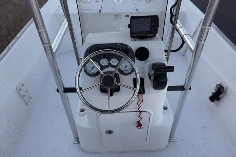 Slide: The Image of 2013 Carolina Skiff 218 boat console with steering wheel and navigation equipment. - 23
