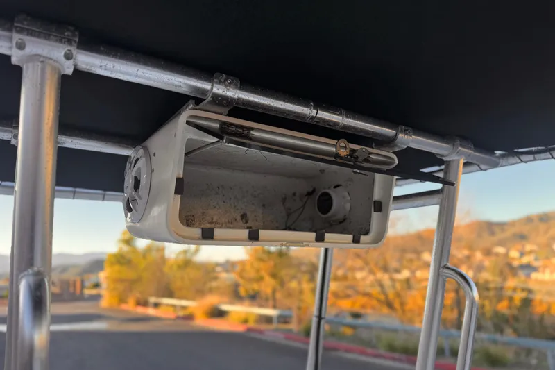 Slide: The Image of 2013 Carolina Skiff 218 boat canopy with mounted light fixture, outdoor setting. - 25