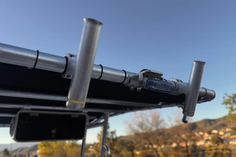 Slide: The Image of 2013 Carolina Skiff 218 boat with rod holders and blue sky background. - 27