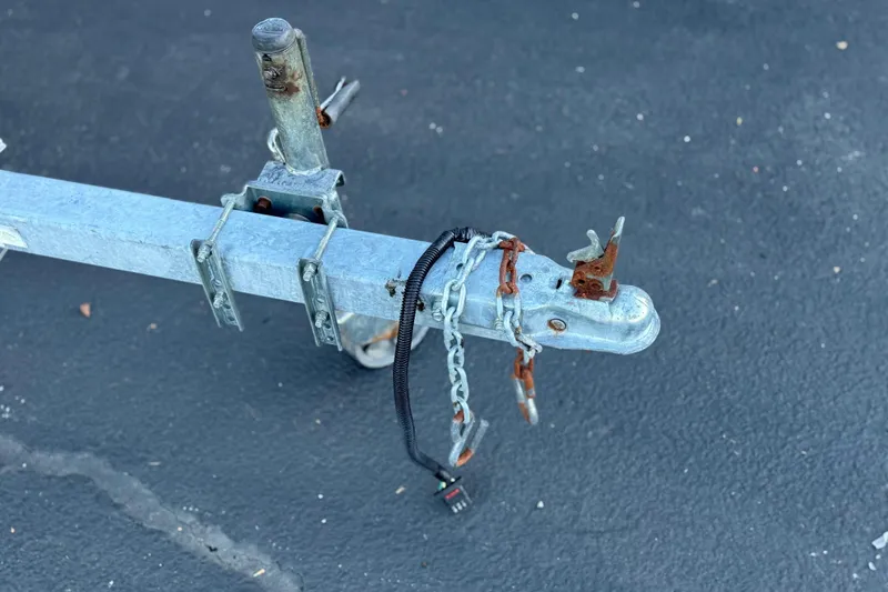 Slide: The Image of Trailer hitch with rusted chains for 2013 Carolina Skiff 218 boat. - 29