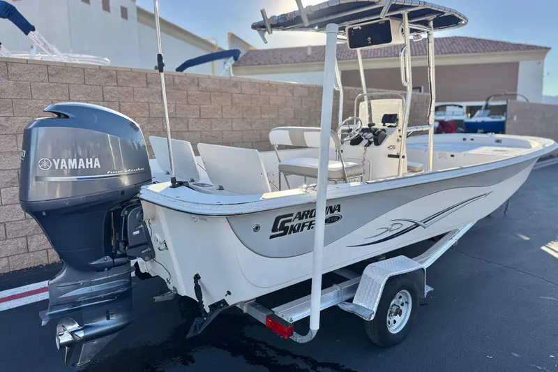 Slide: The Image of 2013 Carolina Skiff 218 boat with Yamaha outboard motor on trailer. - 5
